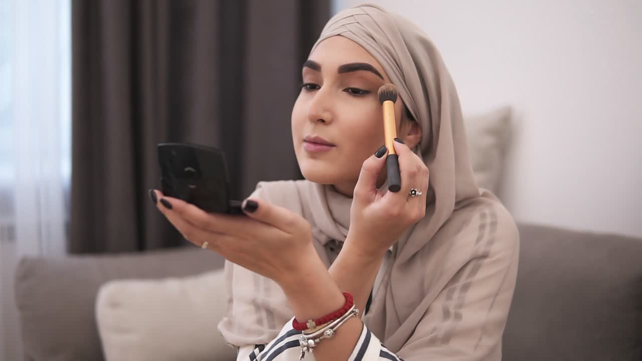 Free stock video - Side view of muslim woman doing makeup on her face ...