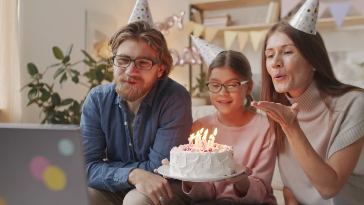 Free stock video - Parents and daughter celebrating birthday wearing ...