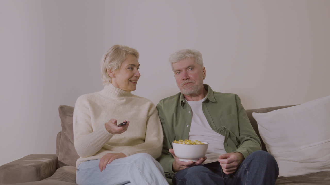 Free stock video - Senior couple talking and watching tv while sitting ...