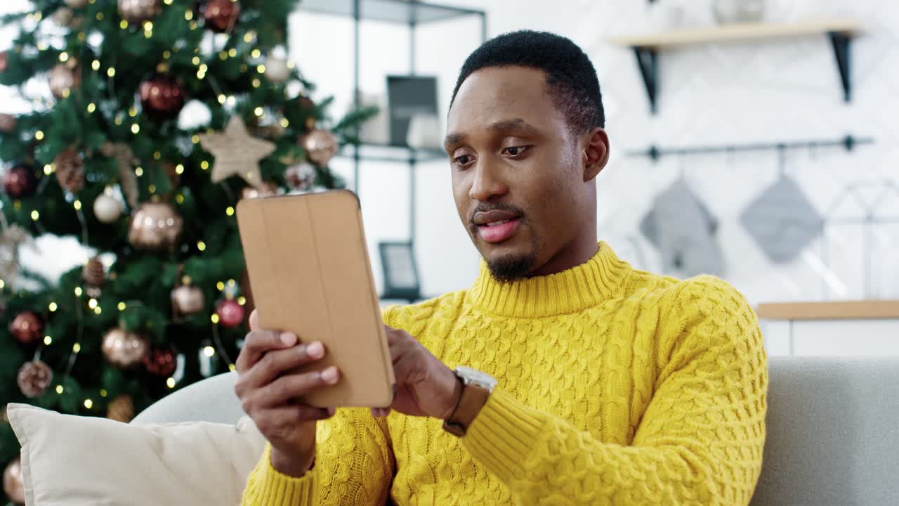 free-stock-video-close-up-portrait-of-happy-man-tapping-on-tablet-and-buying-xmas-gifts-online